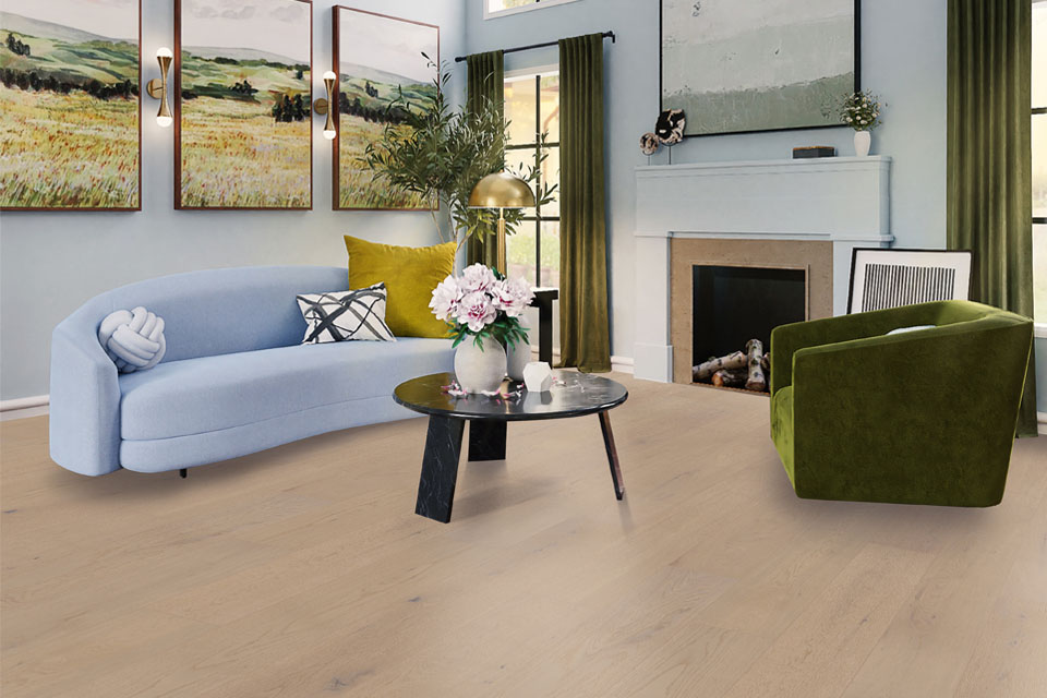 blue couch with green velvet chair and hardwood flooring in living room